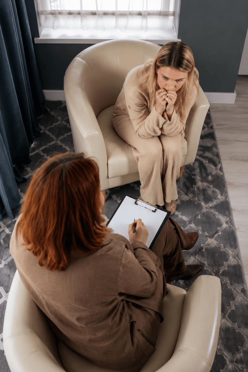 A patient in a quiet moment of conversation with their therapist